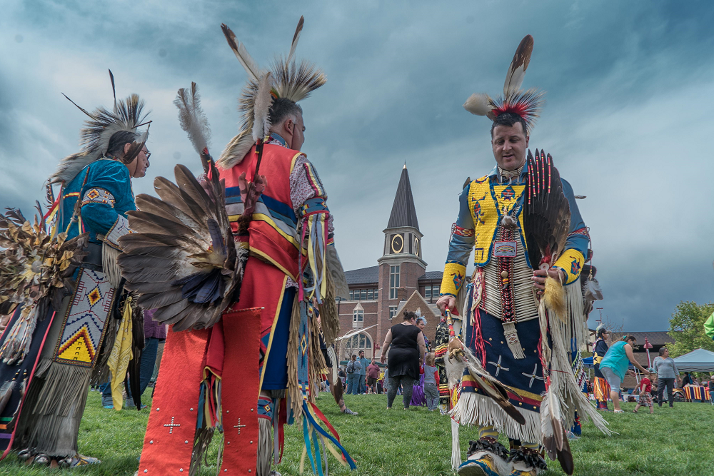 Individuals in Native American clothes on the DU campus