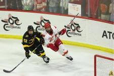 A DU hockey player defends a Colorado College player