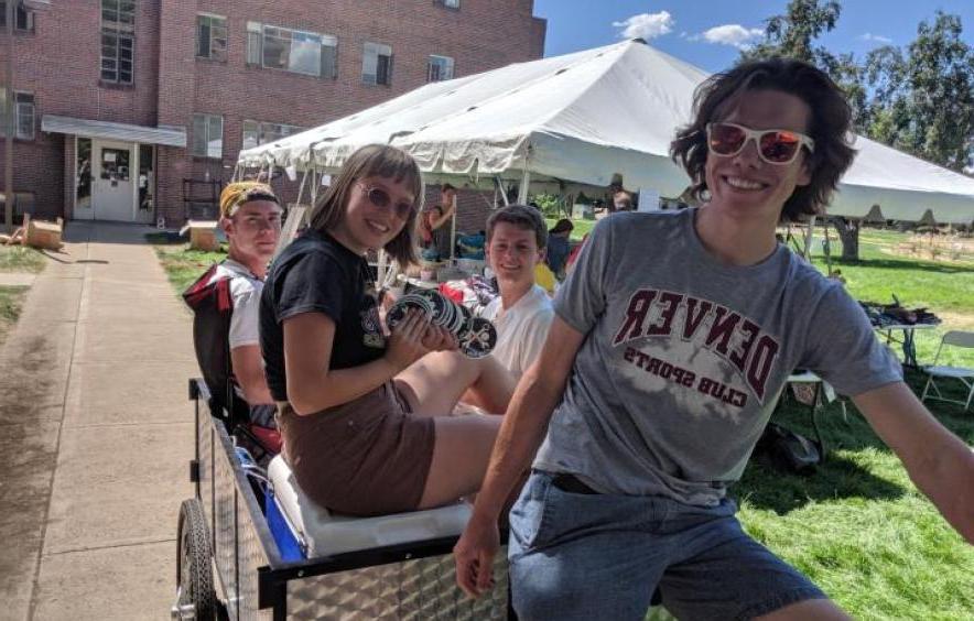 students riding a cargo bike from the center for sustainability