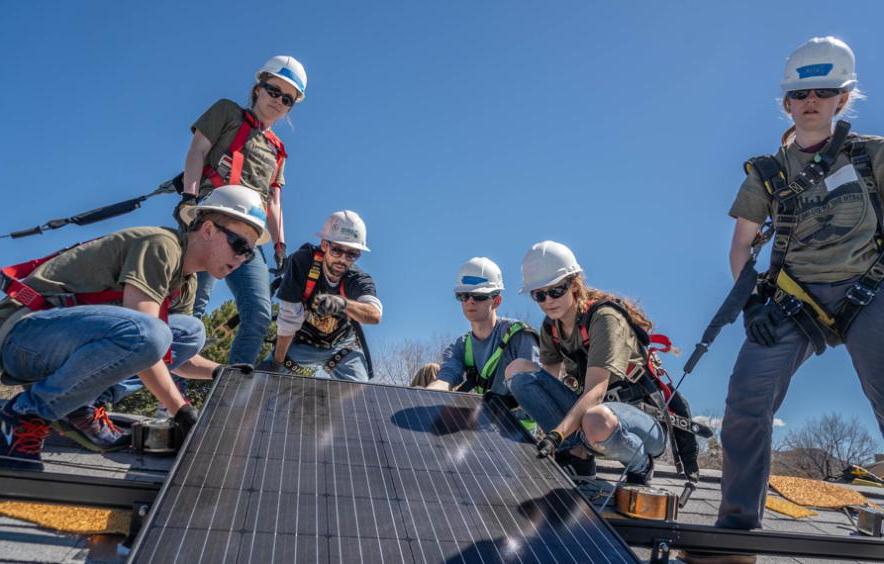 students installing solar panels