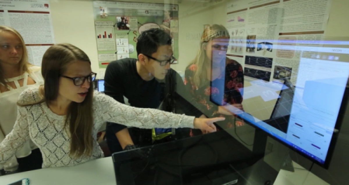 Student pointing at computer screen