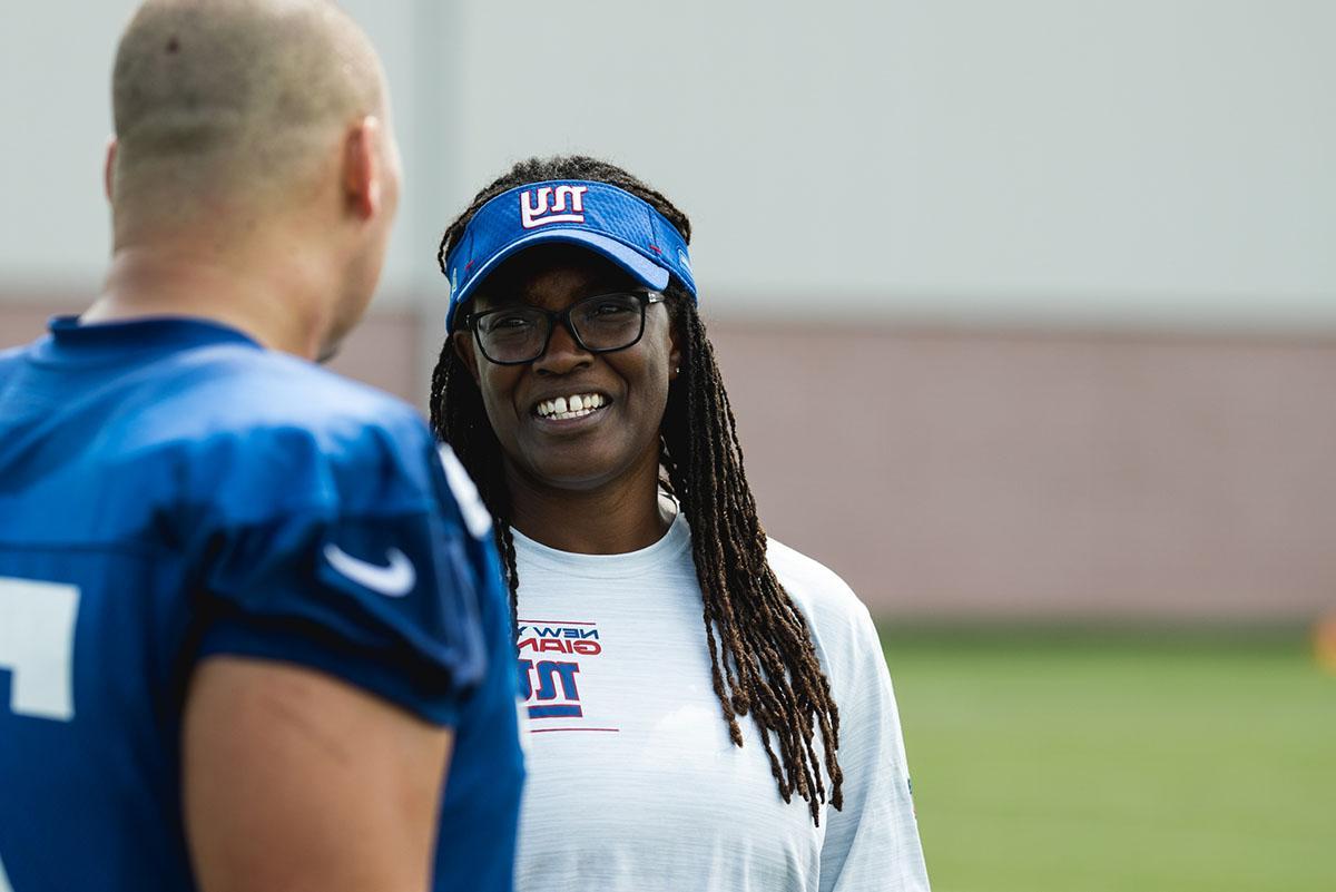 Lani Lawrence speaks with a football player